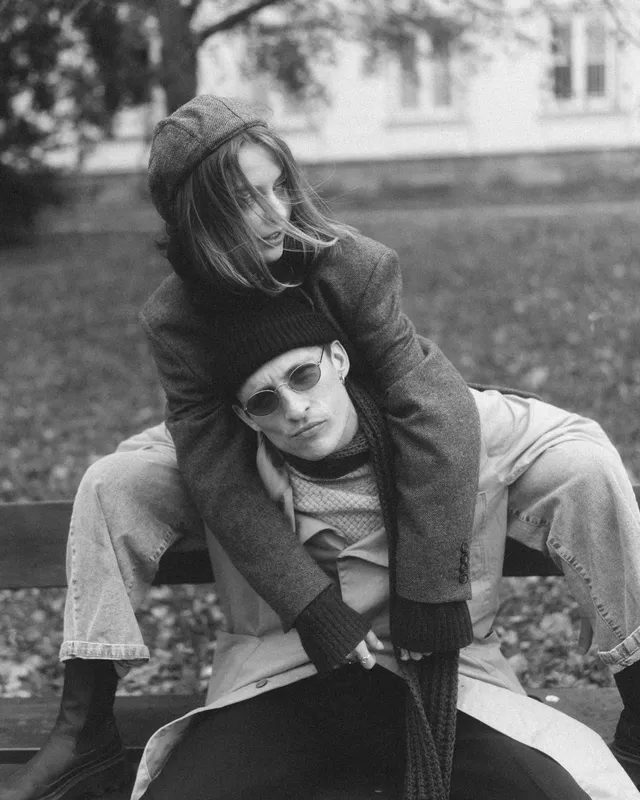 Black and white: Elvira leaning on Sergei's shoulders on a park bench