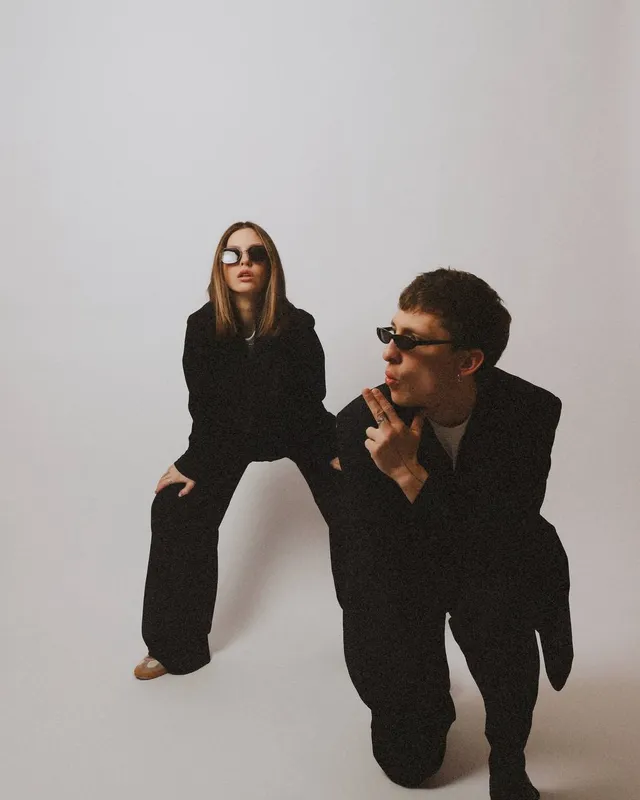 Studio shot: both in sunglasses, Sergei crouching