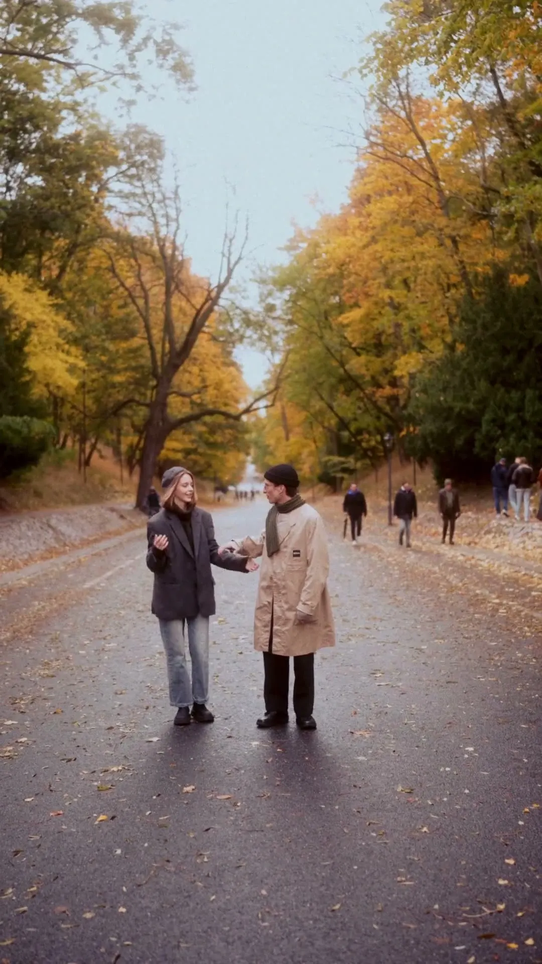 Sergei and Elvira running toward the camera on an autumn road