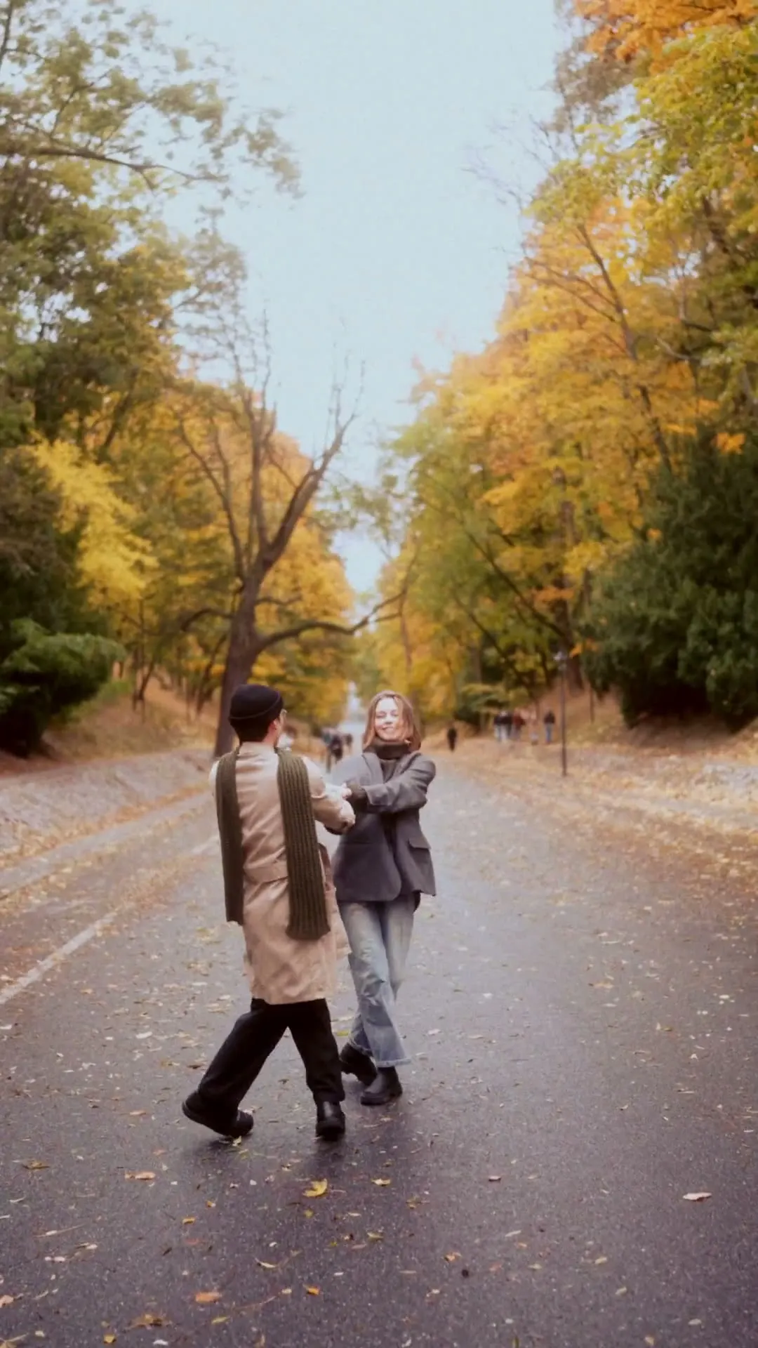 Sergei and Elvira spinning each other around and hugging on the road