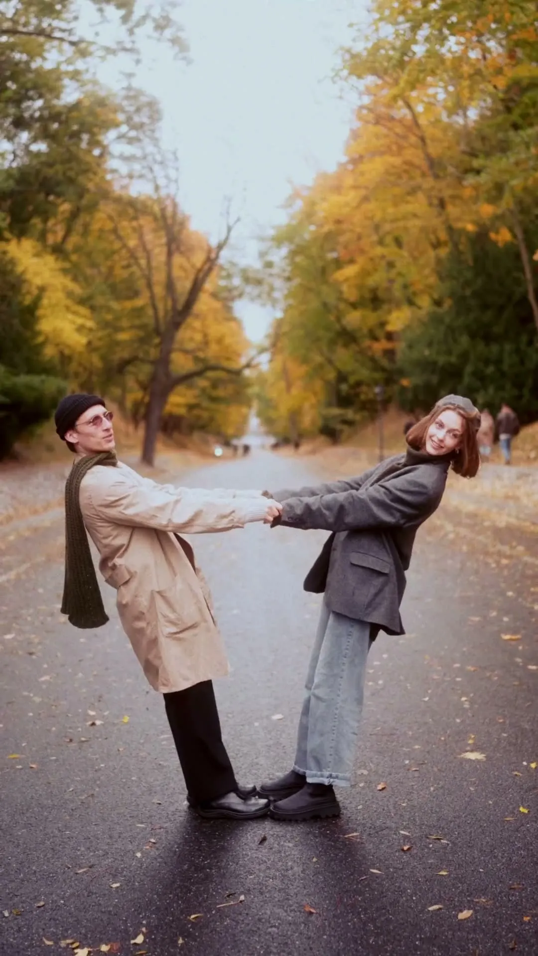 Sergei and Elvira dancing hand in hand on an autumn road