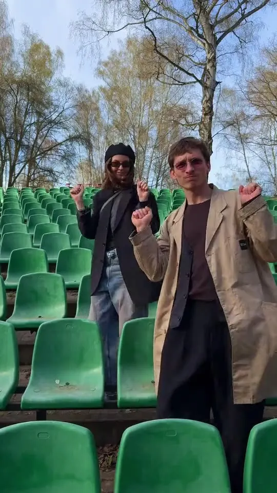 Sergei and Elvira dancing between rows of green stadium seats